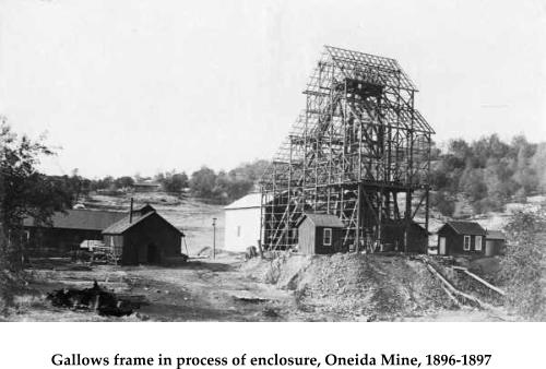 Gallows frame in process of enclosure, Oneida Mine, 1896-1897